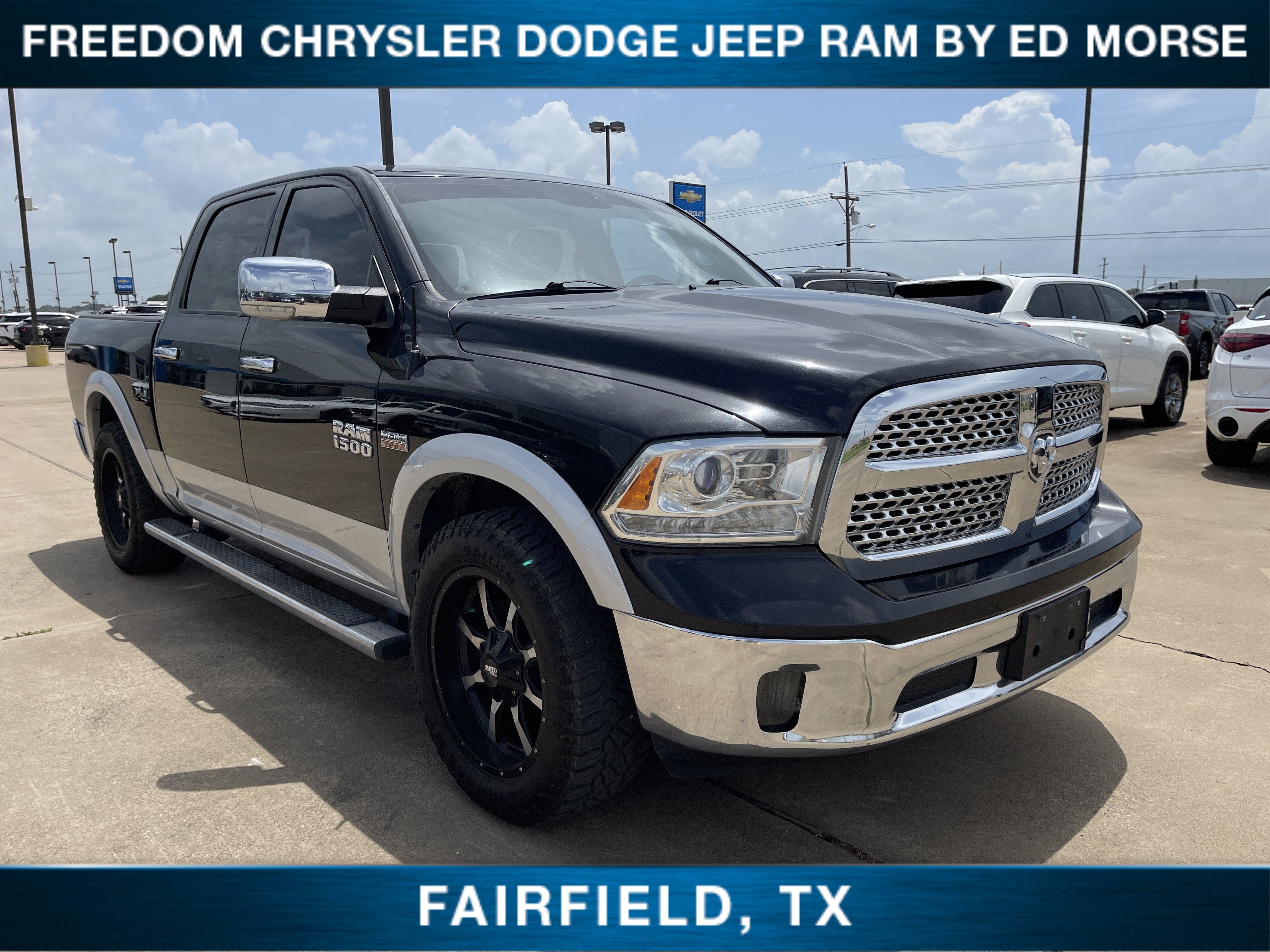 2016 RAM 1500 Laramie in Brilliant Black Crystal Pearlcoat — front three-quarter view