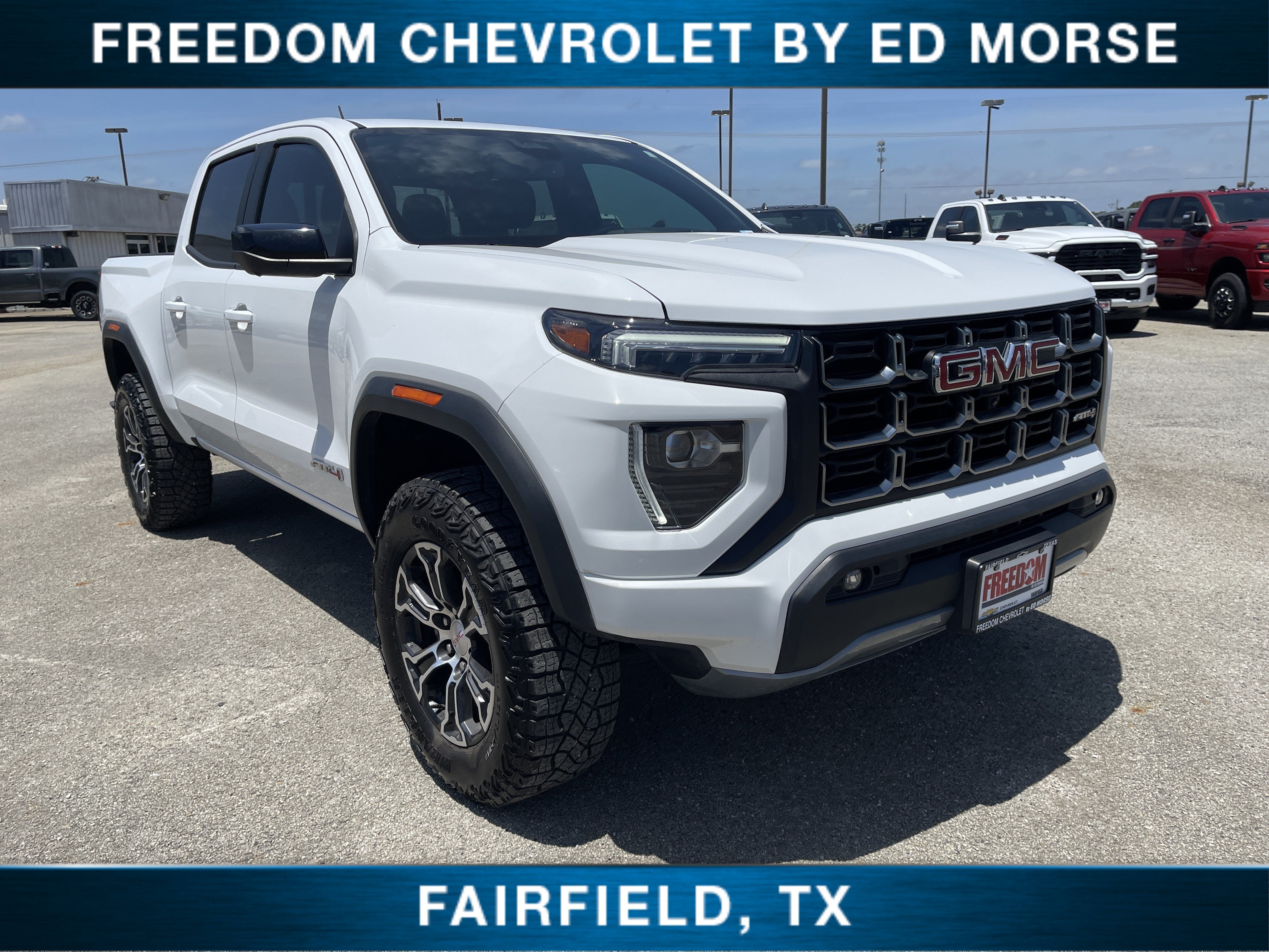 2024 GMC Canyon AT4 in Summit White — front three-quarter view