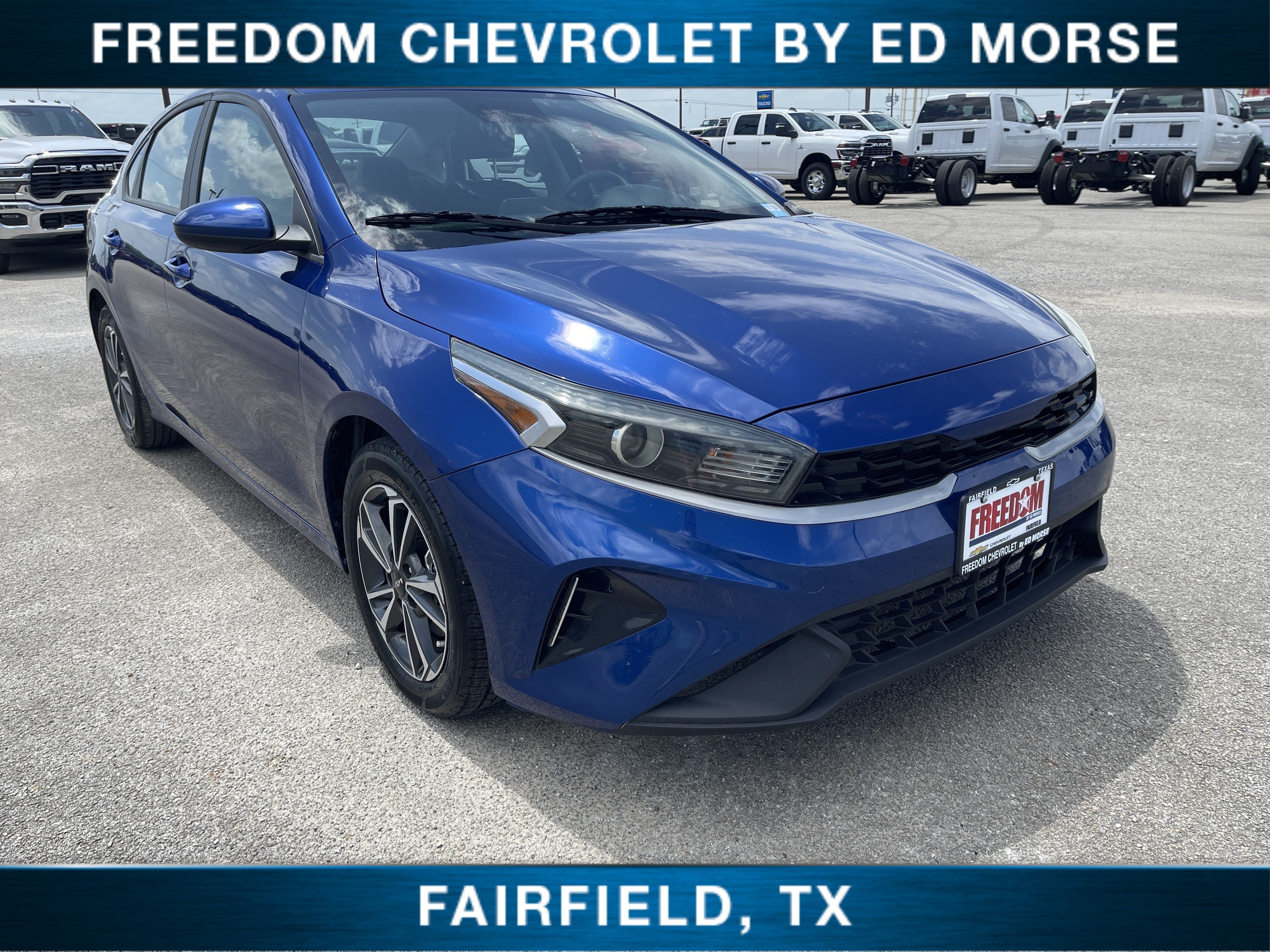 2024 Kia Forte LXS in Blue — front three-quarter view